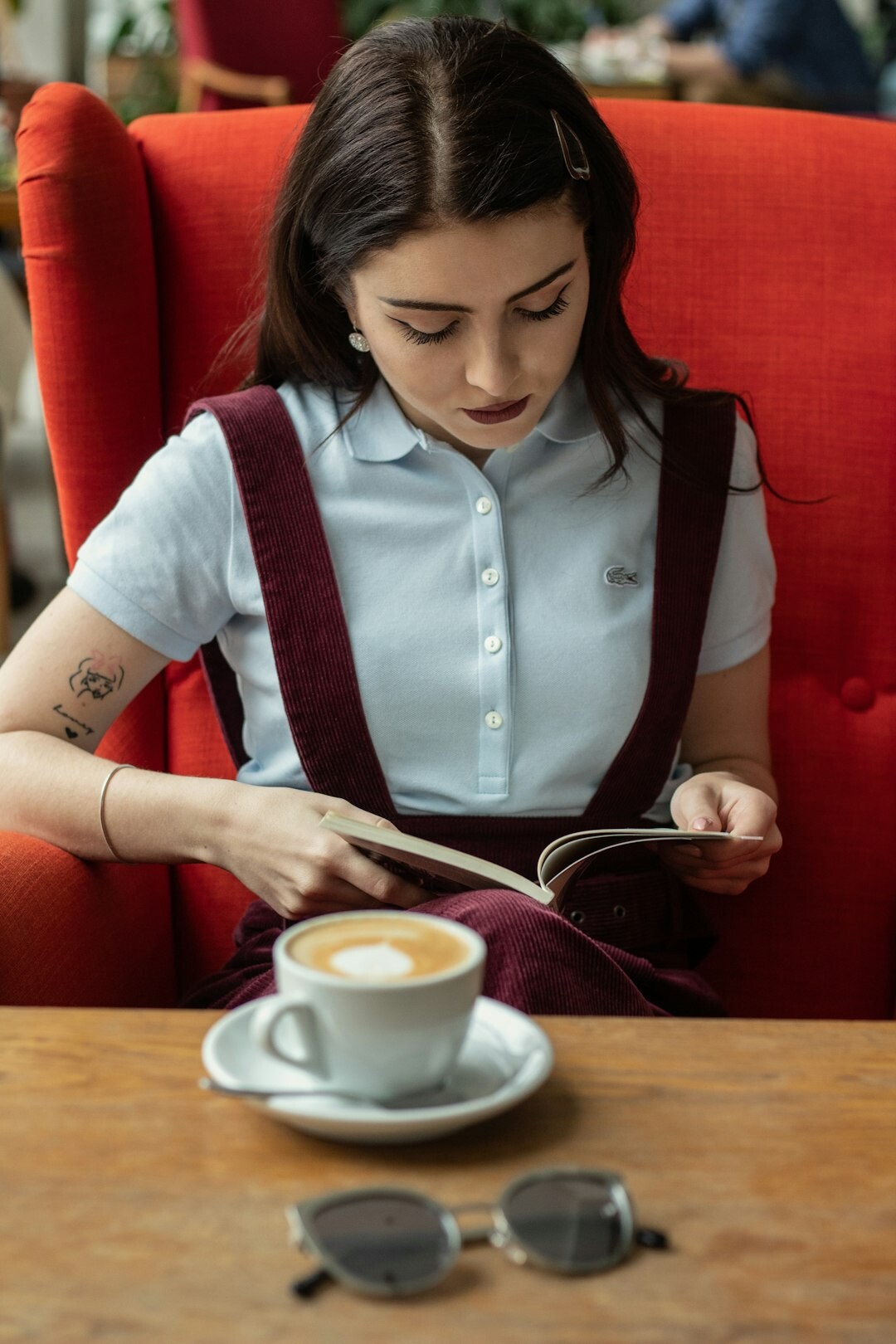 woman reading book in cafe